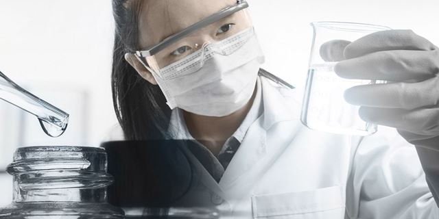 Female chemist analyzing purified water