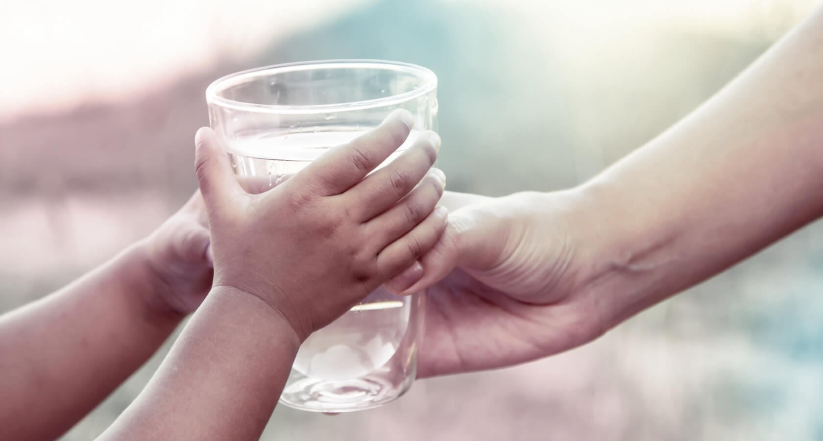 Child gets a glass full of water