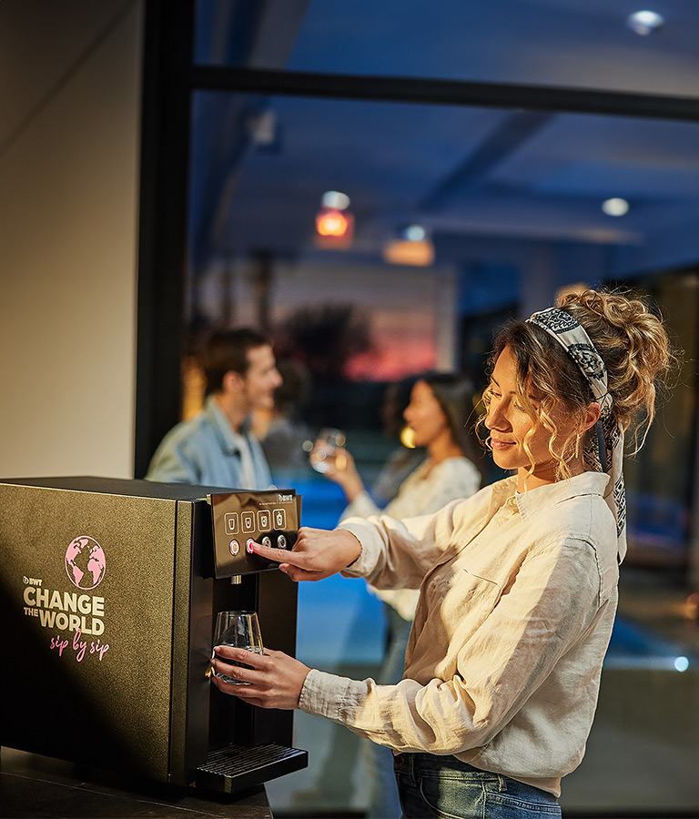 Woman using Waterdispenser