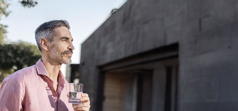 A man holding a glass of water