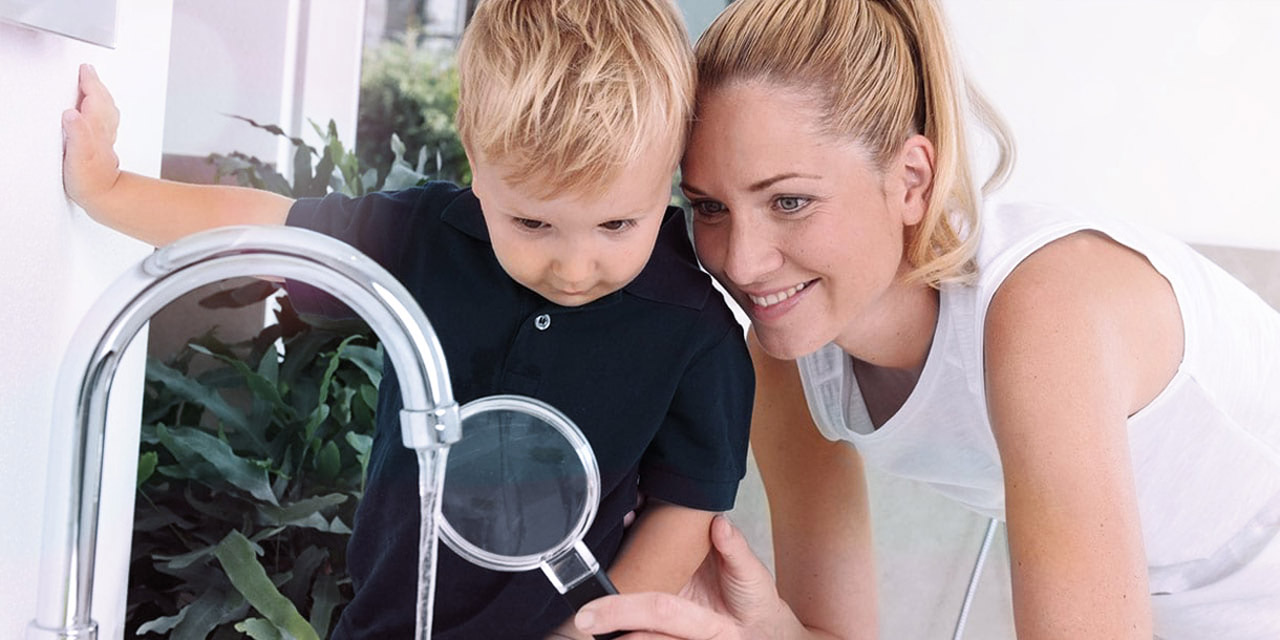 Mother and son taking a closer look at their clean water