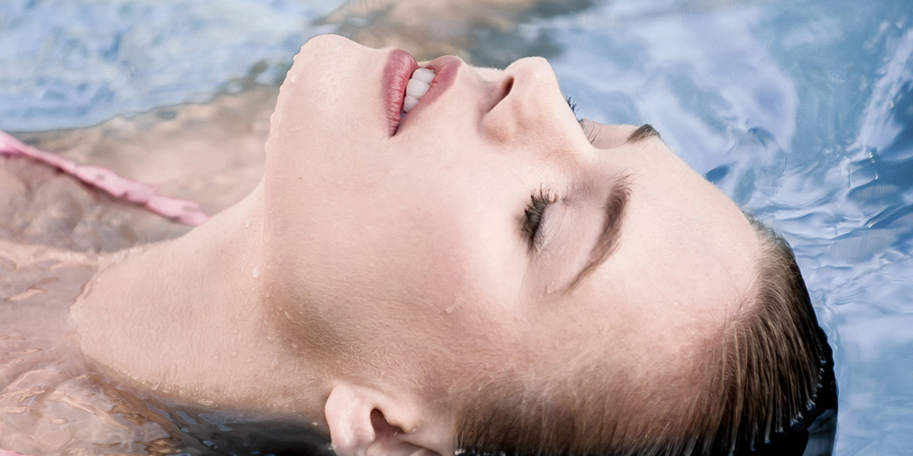Woman relaxing in swimming pool