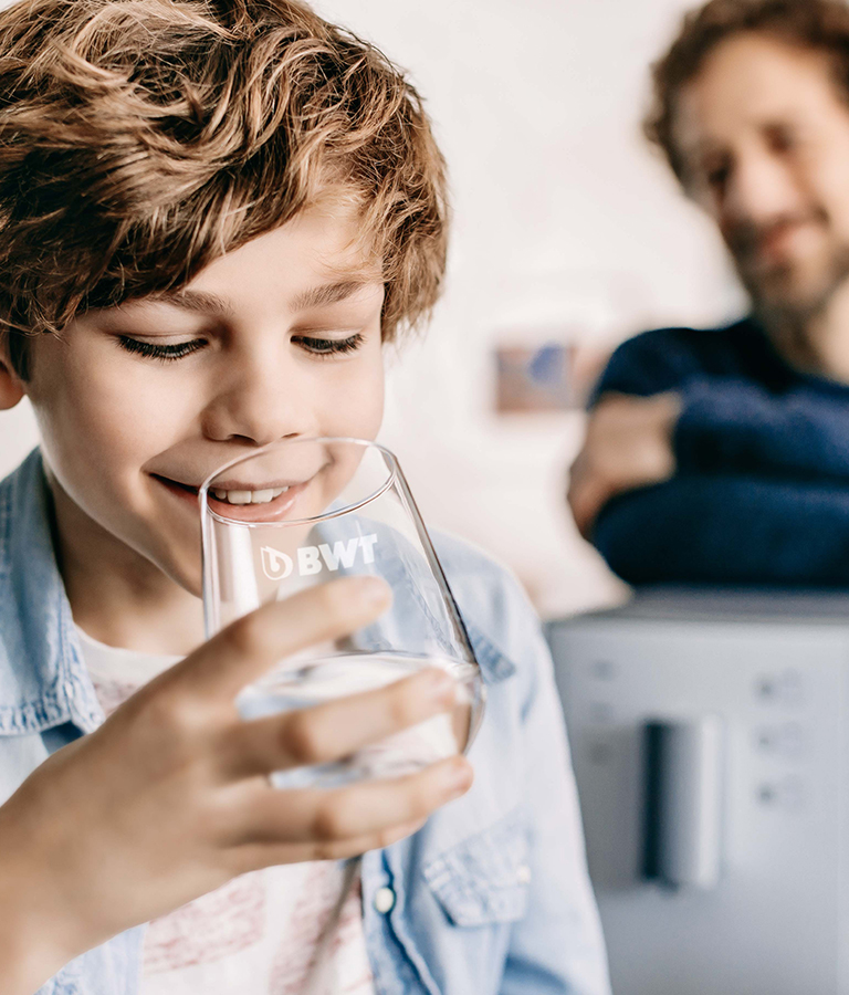 Young boy drinking water