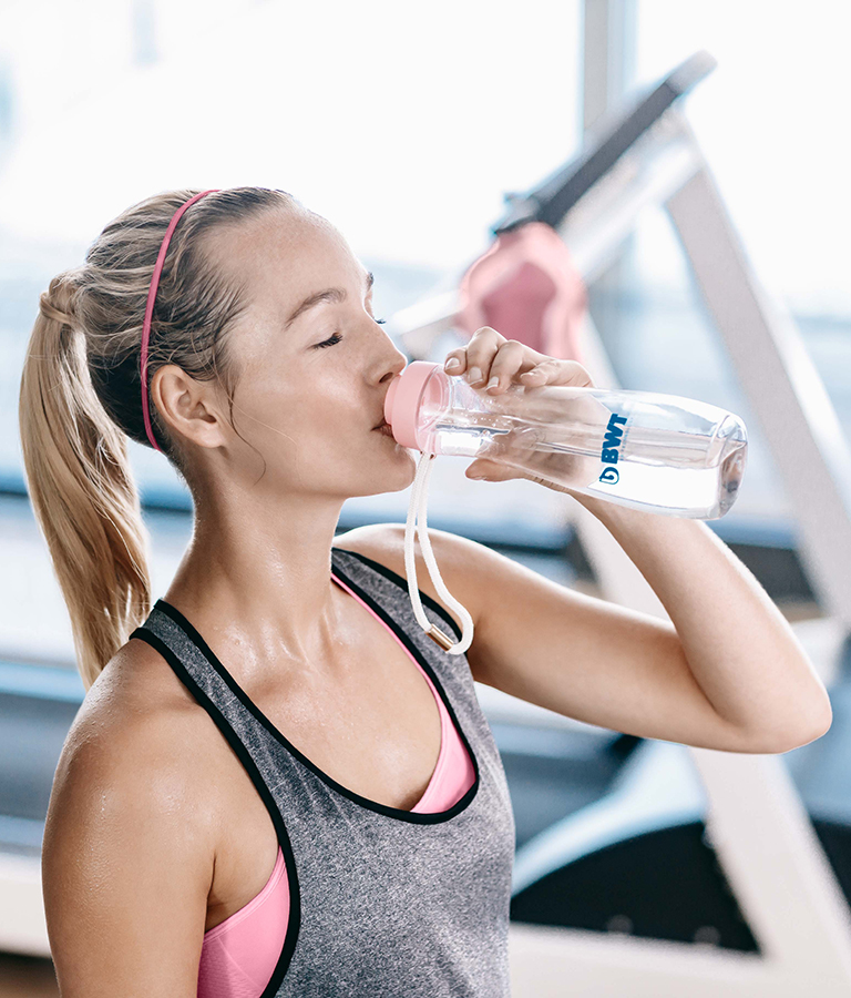 Woman drinking water while running