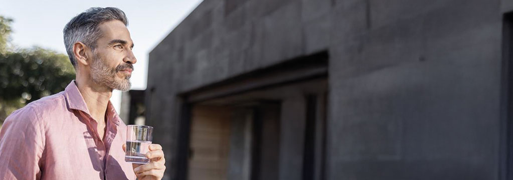 A man holding a glass of water
