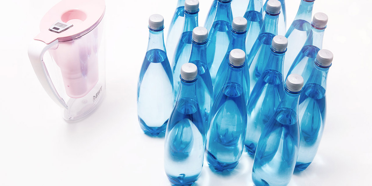 BWT Penguin table water filter next to water bottles